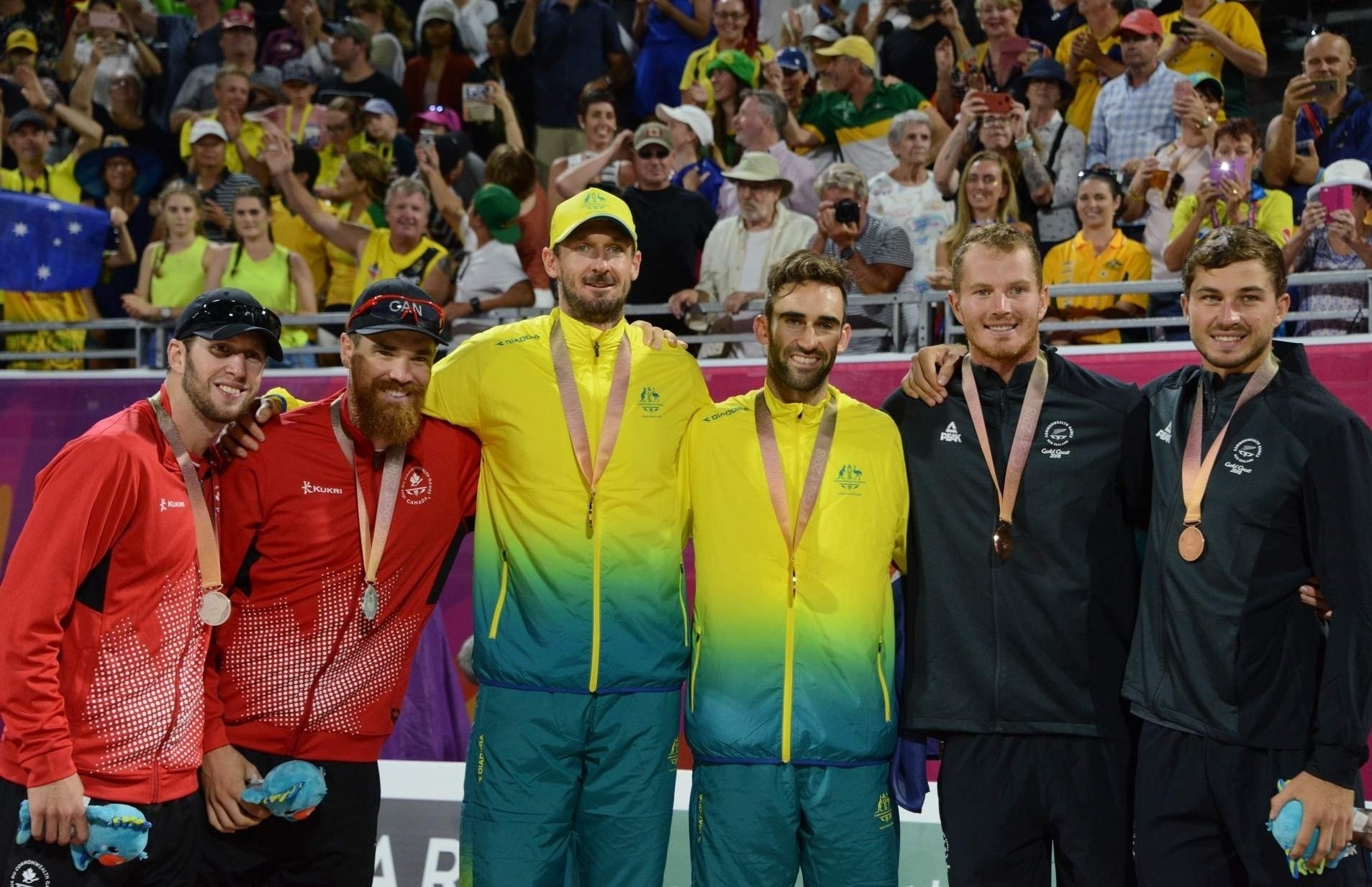 Chris (left, center) and Damien (right, center) top the podium after their dramatic Commonwealth Games final in Gold Coast